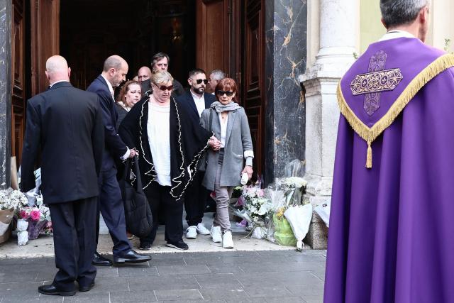 Violette Petrucciani (C), mother of Loana, leaves after attending the funeral ceremony of Loana Petrucciani, the first reality TV star in France, at the cathedral of Sainte-Reparate in Nice, southeastern France where she was found dead at her home at the age of 48, on April 10, 2026. (Photo by Thibaud MORITZ / AFP)