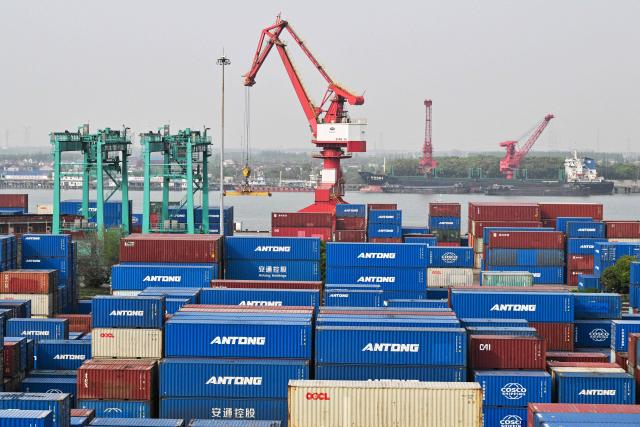General view shows containers stacked up at Jun Gong Road container terminal in Shanghai on April 10, 2026. (Photo by HECTOR RETAMAL / AFP)