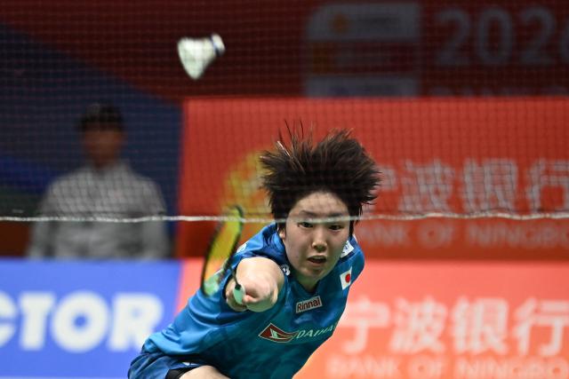 Japan's Akane Yamaguchi hits a return to China's Gao Fang Jie during their women's singles quarter final match at the Badminton Asia Championship in Ningbo, eastern China's Zhejiang province on April 10, 2026. (Photo by CN-STR / AFP) / China OUT