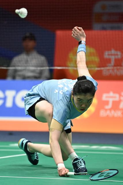 China's Gao Fangjie hits a return to Japan's Akane Yamaguchi during their women's singles quarter final match at the Badminton Asia Championship in Ningbo, eastern China's Zhejiang province on April 10, 2026. (Photo by CN-STR / AFP) / China OUT