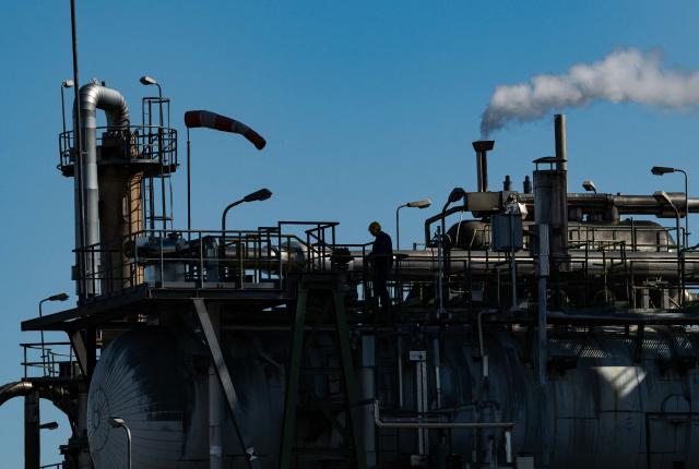 A worker checks out a structure at the SKW Piesteritz agro-chemical plant in Piesteritz near Wittenberg, northern Germany, on April 9, 2026. SKW Piesteritz is Germany’s largest producer of ammonia and urea with an annual output of over four million tonnes, manufacturing both a wide range of industrial chemicals and agrochemical products. (Photo by John MACDOUGALL / AFP)