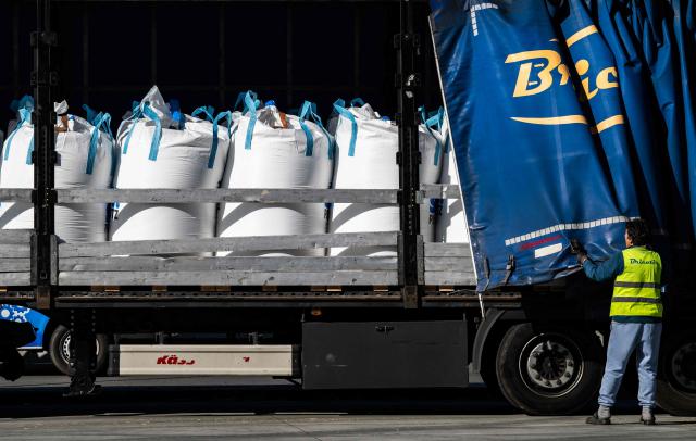 A truck is loaded with bulk bags containing fertilizer at the SKW Piesteritz agro-chemical plant in Piesteritz near Wittenberg, northern Germany, on April 9, 2026. SKW Piesteritz is Germany’s largest producer of ammonia and urea with an annual output of over four million tonnes, manufacturing both a wide range of industrial chemicals and agrochemical products. (Photo by John MACDOUGALL / AFP)