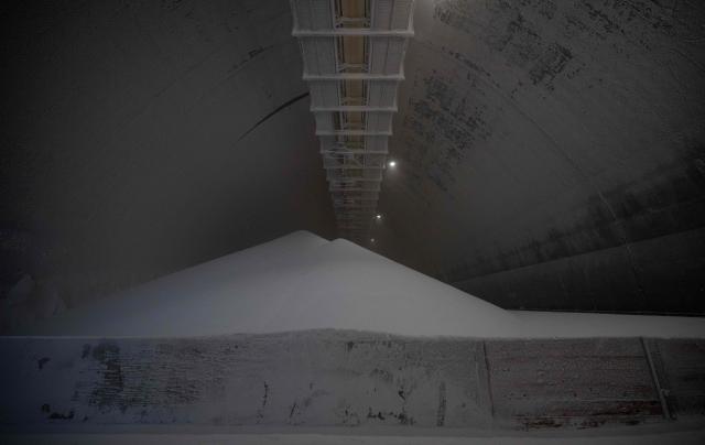 A photo shows a stock pile of granular urea in a storage facilty at the SKW Piesteritz agro-chemical plant in Piesteritz near Wittenberg, northern Germany, on April 9, 2026. SKW Piesteritz is Germany’s largest producer of ammonia and urea with an annual output of over four million tonnes, manufacturing both a wide range of industrial chemicals and agrochemical products. (Photo by John MACDOUGALL / AFP)