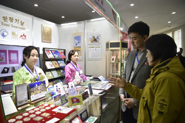 Visitors browse around the Pyongyang International Tourist Souvenirs and Health Goods Exhibition at the Sci-Tech Complex in Pyongyang on April 10, 2026. (Photo by KIM Won Jin / AFP)