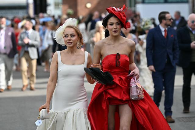 Racegoers arrive on Ladies Day, day two of the Grand National Festival horse race meeting at Aintree Racecourse in Liverpool, north-west England, on April 10, 2026. (Photo by Paul ELLIS / AFP)