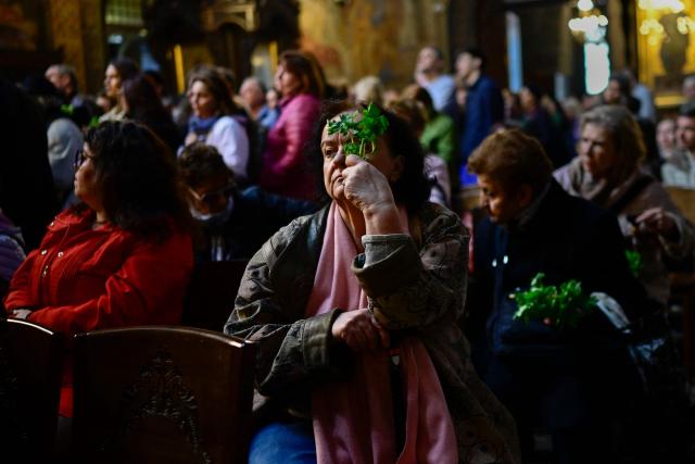 East-Orthodox believer attends a Good Friday service in St Nedelya Church in Sofia on April 10, 2026. (Photo by Nikolay DOYCHINOV / AFP)