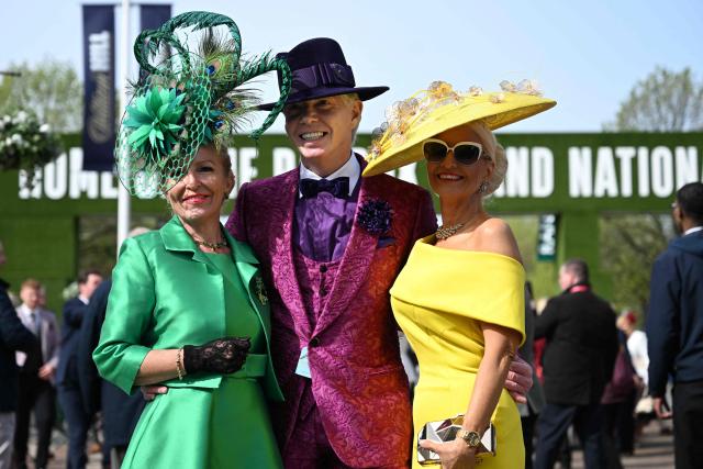 Racegoers pose for a picture on Ladies Day, day two of the Grand National Festival horse race meeting at Aintree Racecourse in Liverpool, north-west England, on April 10, 2026. (Photo by Paul ELLIS / AFP)