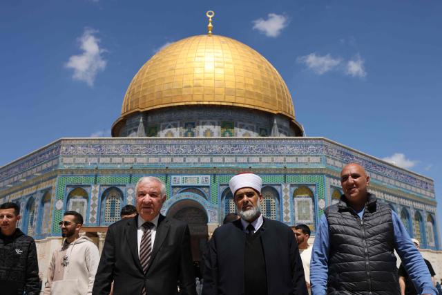 The director of Islamic Waqf in Jerusalem, Sheikh Azzam Khatib (3rd L), stands next to Sheikh Omar al-Kiswani (4th L), director of the Aqsa Mosque, as they walk through the grounds of the Dome of the Rock at the Al-Aqsa Mosque compound during Friday noon prayers, following 40 days of closure by the Israeli authorities, in Jerusalem's Old City on April 10, 2026. The Al-Aqsa Mosque was reopened to Muslim worshippers on April 9, 2026, following a 40-day closure since the US-Israel war with Iran began on February 28. Jerusalem's Old City contains major holy sites for all three Abrahamic religions, which had been shuttered since the start of the war sparked by the US-Israeli attack on Iran. (Photo by AHMAD GHARABLI / AFP) / 