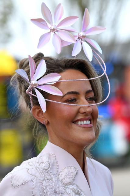 A racegoer smiles on Ladies Day, day two of the Grand National Festival horse race meeting at Aintree Racecourse in Liverpool, north-west England, on April 10, 2026. (Photo by PETER POWELL / AFP)