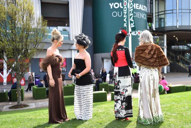 Racegoers mingle in the sunshine on Ladies Day, day two of the Grand National Festival horse race meeting at Aintree Racecourse in Liverpool, north-west England, on April 10, 2026. (Photo by PETER POWELL / AFP)