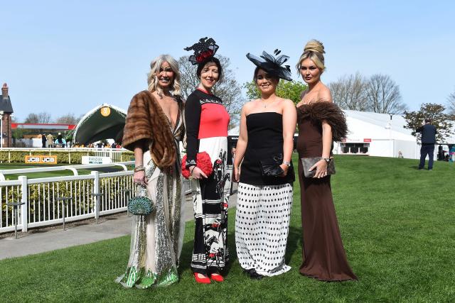 Racegoers pose for a picture on Ladies Day, day two of the Grand National Festival horse race meeting at Aintree Racecourse in Liverpool, north-west England, on April 10, 2026. (Photo by PETER POWELL / AFP)
