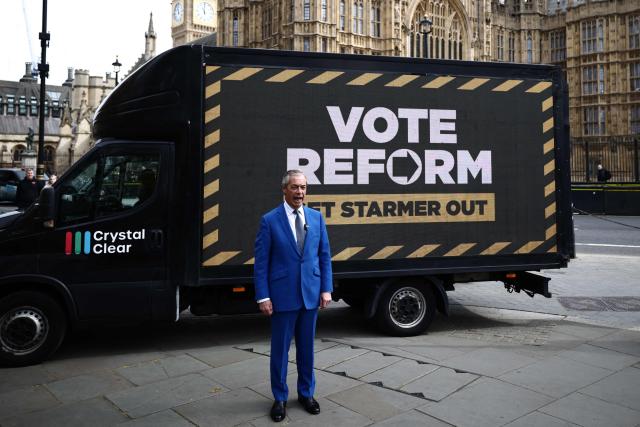 Reform UK leader Nigel Farage poses for members of the media at a photo shoot to publicise a slogan ahead of the local elections in May, in central London on April 10, 2026. (Photo by Henry NICHOLLS / AFP)