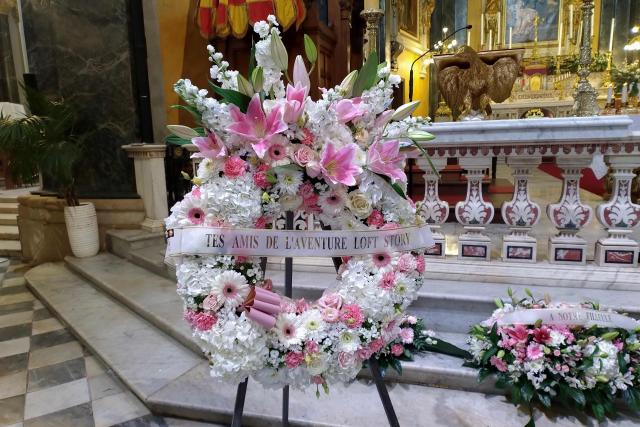 TOPSHOT - This photograph shows a wreath of flowers coming from the Loft Story Loana's friends displayed during the funeral ceremony of Loana Petrucciani, the first reality TV star in France, inside the cathedral of Sainte-Reparate in Nice, southeastern France where she was found dead at her home at the age of 48, on April 10, 2026. (Photo by Fanny CARRIER / AFP)