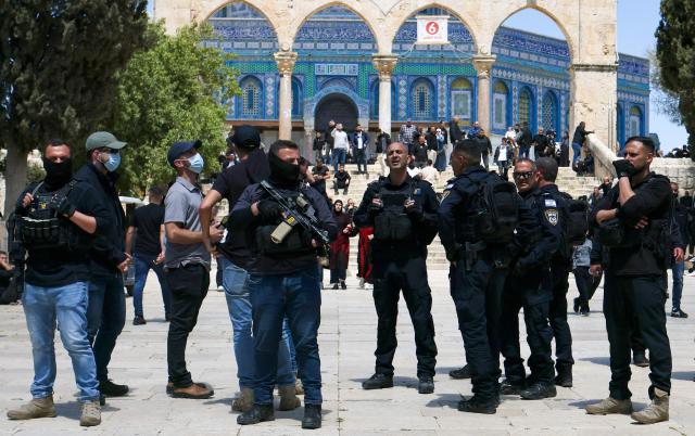 TOPSHOT - Israeli security personnel arrive as Muslim worshippers gather outside the Dome of the Rock within the Al-Aqsa Mosque compound for Friday noon prayers in the Old City of Jerusalem on April 10, 2026. The Al-Aqsa Mosque was reopened to Muslim worshippers on April 9, 2026, following a 40-day closure since the US-Israel war with Iran began on February 28. Jerusalem's Old City contains major holy sites for all three Abrahamic religions, which had been shuttered since the start of the war sparked by the US-Israeli attack on Iran. (Photo by AHMAD GHARABLI / AFP)