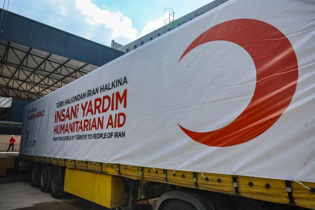 This photograph shows a truck of The Red Cross and Turkey's Red Crescent ready to send supplies to Iran, in Ankara on April 10, 2026. The Red Cross and Turkey's Red Crescent on Friday dispatched an emergency humanitarian aid convoy from Turkey to Iran, as the organisation warned of a "desperate" humanitarian situation in the country. (Photo by Adem ALTAN / AFP)