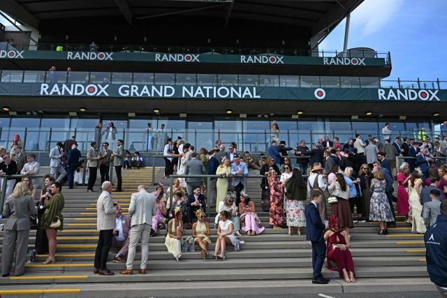 Racegoers mingle on Ladies Day, day two of the Grand National Festival horse race meeting at Aintree Racecourse in Liverpool, north-west England, on April 10, 2026. (Photo by Paul ELLIS / AFP)