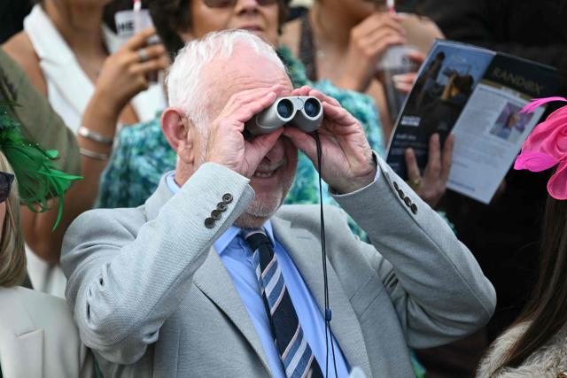 A racegoer watches the opening race on day two of the Grand National Festival horse race meeting at Aintree Racecourse in Liverpool, north-west England, on April 10, 2026. (Photo by Paul ELLIS / AFP)