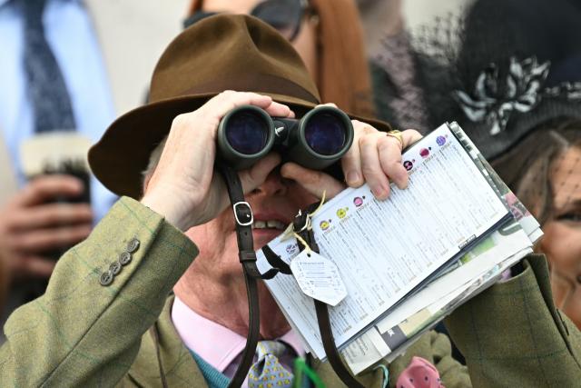A racegoer watches the opening race on day two of the Grand National Festival horse race meeting at Aintree Racecourse in Liverpool, north-west England, on April 10, 2026. (Photo by Paul ELLIS / AFP)