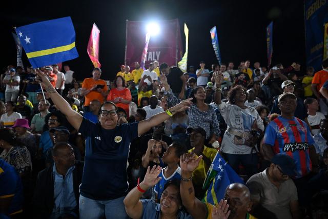 Football fans cheer during the Legends Football Tournament  in Willemstad, Curacao, in the Dutch Caribbean, on April 9, 2026. (Photo by Raul ARBOLEDA / AFP)