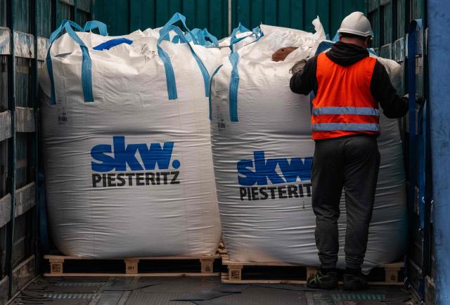 A worker loads bulk bags containing unprocessed urea (unkonditionierter Harnstoff) onto a truck at the SKW Piesteritz agro-chemical plant in Piesteritz near Wittenberg, northern Germany, on April 9, 2026. SKW Piesteritz is Germany’s largest producer of ammonia and urea with an annual output of over four million tonnes, manufacturing both a wide range of industrial chemicals and agrochemical products. (Photo by John MACDOUGALL / AFP)