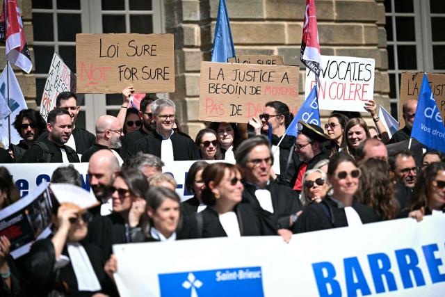 Lawyers take part in a gathering in front of the Parlement of Brittany building as part of a national strike against a bill on criminal justice and respect for victims, in Rennes, western France, on April 10, 2026. (Photo by Lou BENOIST / AFP)