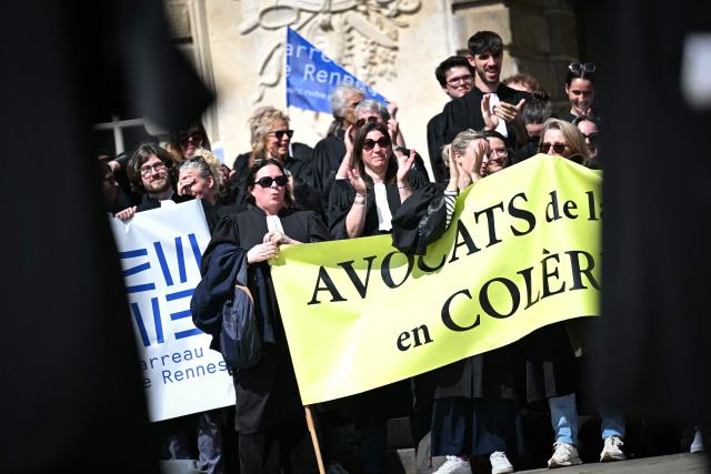 Lawyers take part in a gathering in front of the Parlement of Brittany building as part of a national strike against a bill on criminal justice and respect for victims, in Rennes, western France, on April 10, 2026. (Photo by Lou BENOIST / AFP)