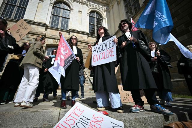 Lawyers take part in a gathering in front of the Parlement of Brittany building as part of a national strike against a bill on criminal justice and respect for victims, in Rennes, western France, on April 10, 2026. (Photo by Lou BENOIST / AFP)