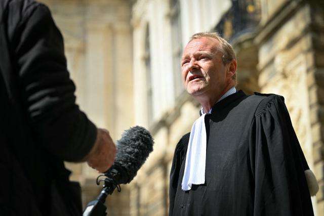 Paul Delacourt, new member of the Rennes bar, speaks to journalists during a lawyers' gathering in front of the Parlement of Brittany building as part of a national strike against a bill on criminal justice and respect for victims, in Rennes, western France, on April 10, 2026. (Photo by Lou BENOIST / AFP)