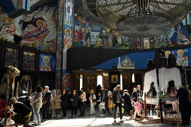 Faithfuls queue to touch a wooden statue of Jesus  Christ during a Good Friday service at the main Orthodox church St. Kliment of Ohrid in Skopje on April 10, 2026. The North Macedonian Orthodox Church celebrates Easter according to the Julian calendar. (Photo by Robert ATANASOVSKI / AFP)