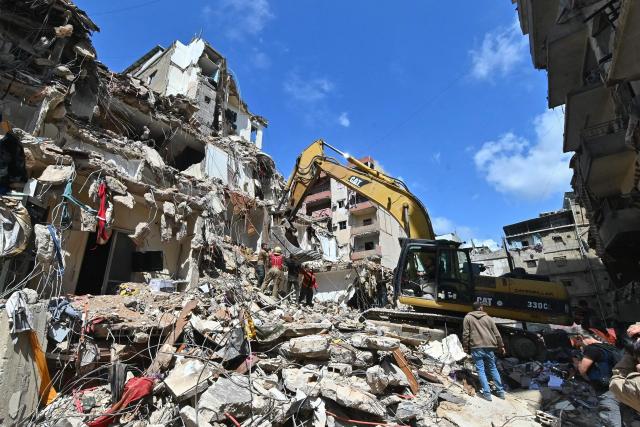 This photograph taken on April 10, 2026, during a media tour organized by Hezbollah’s media office shows a digger clearing the rubble of a building in Beirut's Hay al-Selloum neighbourhood, that was targetted in an Israeli strike earlier this week. The Israeli military said on April 10 that it had "dismantled" more than 4,300 Hezbollah sites in Lebanon since fighting with the militant group began last month. (Photo by FADEL itani / AFP)