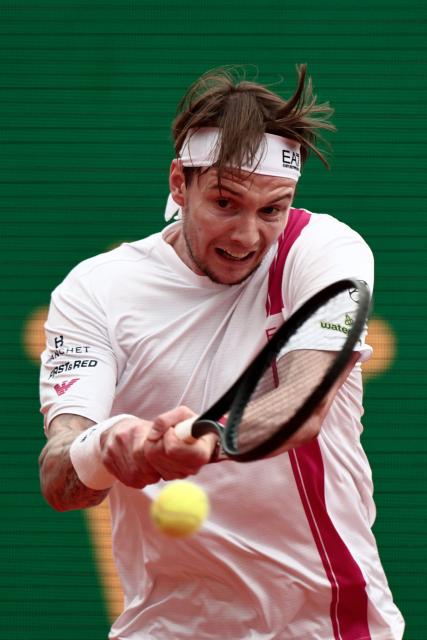 Kazakhstan's Alexander Bublik plays a backhand return to Spain's Carlos Alcaraz during the Monte Carlo ATP Masters Series Tournament quarter final tennis match on Court Rainier III at the Monte-Carlo Country Club in Roquebrune-Cap-Martin, south-eastern France on April 10, 2026. (Photo by Thibaud MORITZ / AFP)