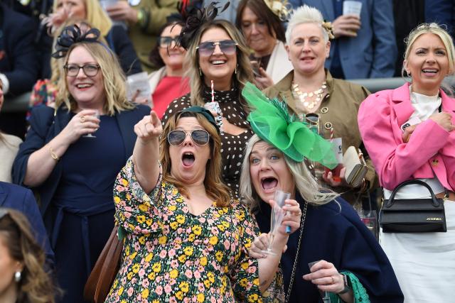 Racegoers react to the finish of the Melling Chase on day two of the Grand National Festival horse race meeting at Aintree Racecourse in Liverpool, north-west England, on April 10, 2026. (Photo by PETER POWELL / AFP)