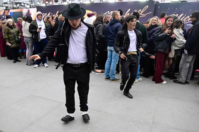 Michael Jackson fans show their dance moves as they wait for guests to arrive on the red carptet for the world premiere of the Michael Jackson biopic "Michael" at the Uber Eats Music Hall in Berlin on April 10, 2026. Thousands of Michael Jackson fans converged on April 10, 2026 to Berlin before the world premiere of the biopic on the king of pop, despite the accusations of paedophilia that still target the artist. (Photo by John MACDOUGALL / AFP)