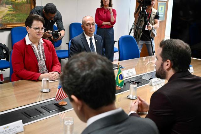 Brazil’s Finance Minister Dario Durigan (L) speaks during a meeting with the US Embassy Chargй d’Affaires Kim Kelly (L), before signing a cooperation agreement between the Brazilian Federal Revenue Service (RFB) and US Customs and Border Protection (CBP) to combat transnational crime, in Brasнlia, Brazil, on April 10. 2026. This cooperation was established based on discussions between Brazil’s President Lula da Silva and U.S. President Donald Trump. (Photo by Evaristo Sa / AFP)