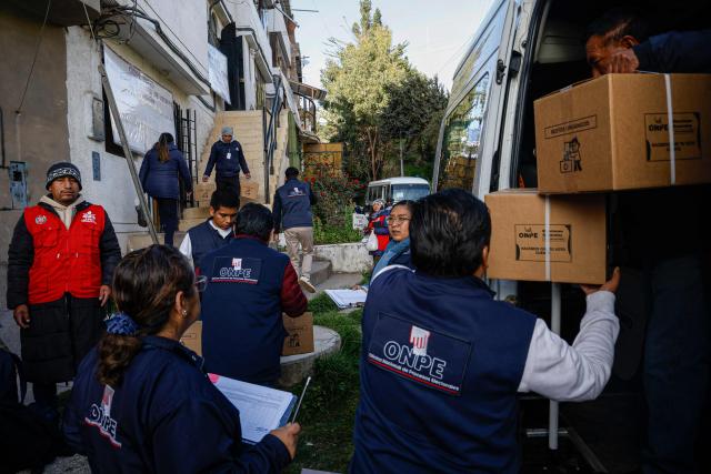 Workers from the National Office of Electoral Processes (ONPE) carry electoral material that will be taken by boat to the islands of Amantani and Taquile in Lake Titicaca in Puno, southern Peru, on April 10, 2026. Peru, which has had eight presidents in ten years, will hold general election next April 12, 2026. A recent poll shows that public distrust of the political class is running deep as 16 percent of voters remain undecided, while another 11 percent plan to cast a blank ballot  a striking figure given that voting is compulsory. (Photo by Juan Carlos CISNEROS / AFP)