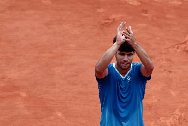 Spain's Carlos Alcaraz applauds as he celebrates after winning against Kazakhstan's Alexander Bublik during the Monte Carlo ATP Masters Series Tournament quarter final tennis match on Court Rainier III at the Monte-Carlo Country Club in Roquebrune-Cap-Martin, south-eastern France on April 10, 2026. (Photo by Thibaud MORITZ / AFP)