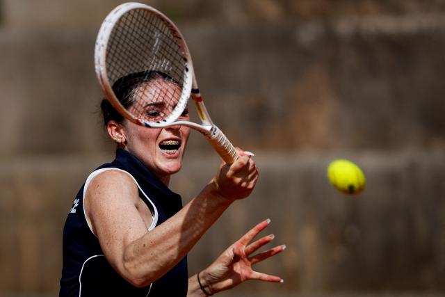 France's Elsa Jacquemot hits a return in her women's singles match against Hungary’s Anna Bondar during the Billie Jean King Cup play-offs between France and Hungary, at Oeiras on the outskirts of Lisbon, on April 10, 2026. (Photo by FILIPE AMORIM / AFP)