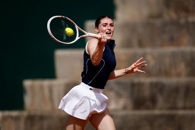 France's Elsa Jacquemot hits a return in her women's singles match against Hungary’s Anna Bondar during the Billie Jean King Cup play-offs between France and Hungary, at Oeiras on the outskirts of Lisbon, on April 10, 2026. (Photo by FILIPE AMORIM / AFP)