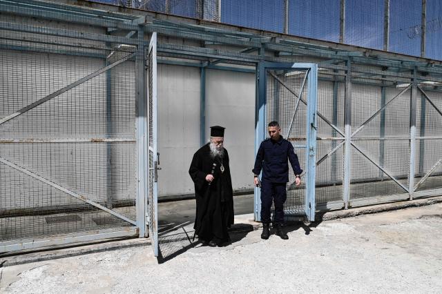 Metropolitan Bishop of Grevena enters the Grevena prison during a Good Friday ceremony marking the Apokathelosis, the removal of Christ's body from the cross, on April 10, 2026. Millions of worshippers flock to churches all week long to celebrate Easter, the foremost celebration in Orthodox faith. (Photo by Sakis Mitrolidis / AFP)