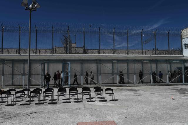 Inmates arrive to attend a church service following the Epitafios procession at the Church of Agios Eleftherios inside the Grevena prison, on April 10, 2026. Millions of worshippers flock to churches all week long to celebrate Easter, the foremost celebration in Orthodox faith. (Photo by Sakis Mitrolidis / AFP)