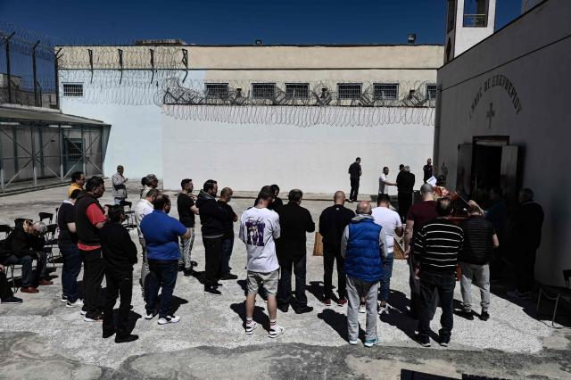 Inmates attend a church service following the Epitafios procession at the Church of Agios Eleftherios inside the Grevena prison, on April 10, 2026. Millions of worshippers flock to churches all week long to celebrate Easter, the foremost celebration in Orthodox faith. (Photo by Sakis Mitrolidis / AFP)