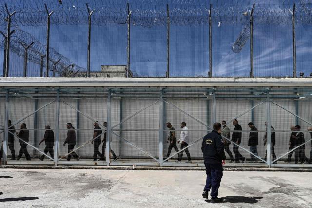 Inmates arrive to attend a church service following the Epitafios procession at the Church of Agios Eleftherios inside the Grevena prison, on April 10, 2026. Millions of worshippers flock to churches all week long to celebrate Easter, the foremost celebration in Orthodox faith. (Photo by Sakis Mitrolidis / AFP)