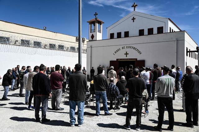 Inmates attend a church service following the Epitafios procession at the Church of Agios Eleftherios inside the Grevena prison, on April 10, 2026. Millions of worshippers flock to churches all week long to celebrate Easter, the foremost celebration in Orthodox faith. (Photo by Sakis Mitrolidis / AFP)