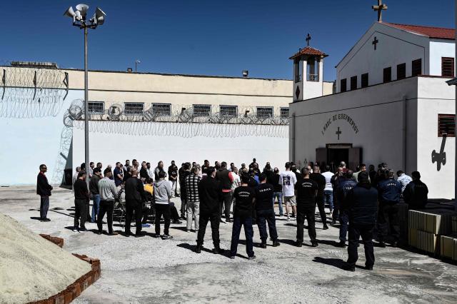 Inmates attend a church service following the Epitafios procession at the Church of Agios Eleftherios inside the Grevena prison, on April 10, 2026. Millions of worshippers flock to churches all week long to celebrate Easter, the foremost celebration in Orthodox faith. (Photo by Sakis Mitrolidis / AFP)