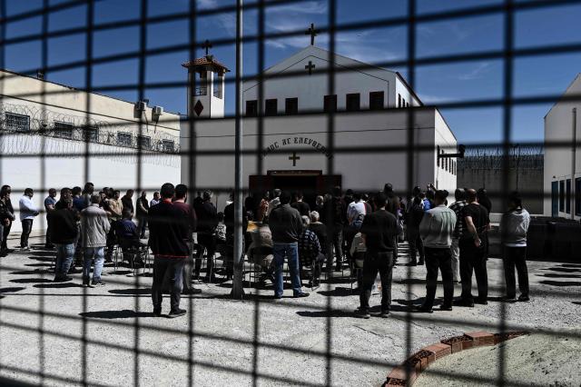 Inmates attend a church service following the Epitafios procession at the Church of Agios Eleftherios inside the Grevena prison, on April 10, 2026. Millions of worshippers flock to churches all week long to celebrate Easter, the foremost celebration in Orthodox faith. (Photo by Sakis Mitrolidis / AFP)