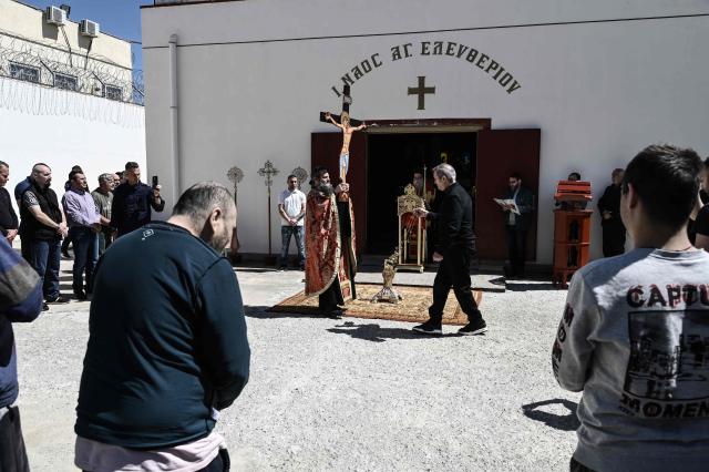 Inmates attend a church service following the Epitafios procession at the Church of Agios Eleftherios inside the Grevena prison, on April 10, 2026. Millions of worshippers flock to churches all week long to celebrate Easter, the foremost celebration in Orthodox faith. (Photo by Sakis Mitrolidis / AFP)