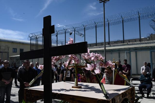 Inmates attend a church service following the Epitafios procession at the Church of Agios Eleftherios inside the Grevena prison, on April 10, 2026. Millions of worshippers flock to churches all week long to celebrate Easter, the foremost celebration in Orthodox faith. (Photo by Sakis Mitrolidis / AFP)