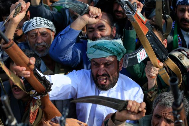 Supporters of the Iran-backed Houthi movement brandish their weapons as they rally in solidarity with Iran and Lebanon in the Yemeni capital Sanaa on April 10, 2026. Pakistan was poised on April 10, to host Iranian and US delegations for negotiations in its capital, although Tehran's participation remained uncertain after deadly Israeli strikes on Lebanon threatened this week's temporary truce. (Photo by Mohammed HUWAIS / AFP)