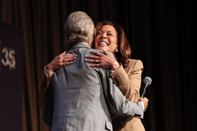 Former US Vice President Kamala Harris embraces Reverend Al Sharpton at the National Action Network (NAN) convention in New York on April 10, 2026. (Photo by TIMOTHY A. CLARY / AFP)