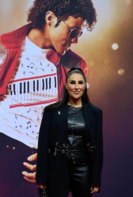 German singer Senna Gammour poses for photogaphers as she arrive on the red carptet for the world premiere of the Michael Jackson biopic "Michael" at the Uber Eats Music Hall in Berlin on April 10, 2026. Thousands of Michael Jackson fans converged on April 10, 2026 to Berlin before the world premiere of the biopic on the king of pop, despite the accusations of paedophilia that still target the artist. (Photo by John MACDOUGALL / AFP)
